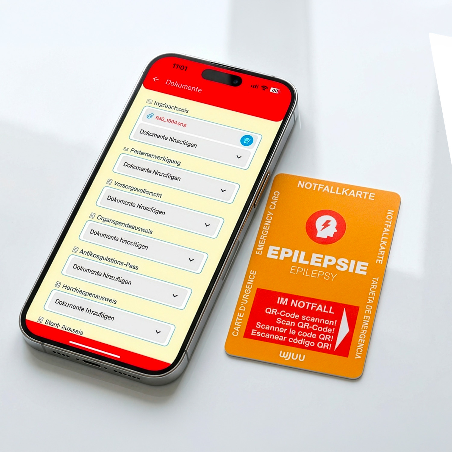Wjuu Notfallkarte für Epileptiker neben Smartphone mit digitalem Profil und Dokumenten