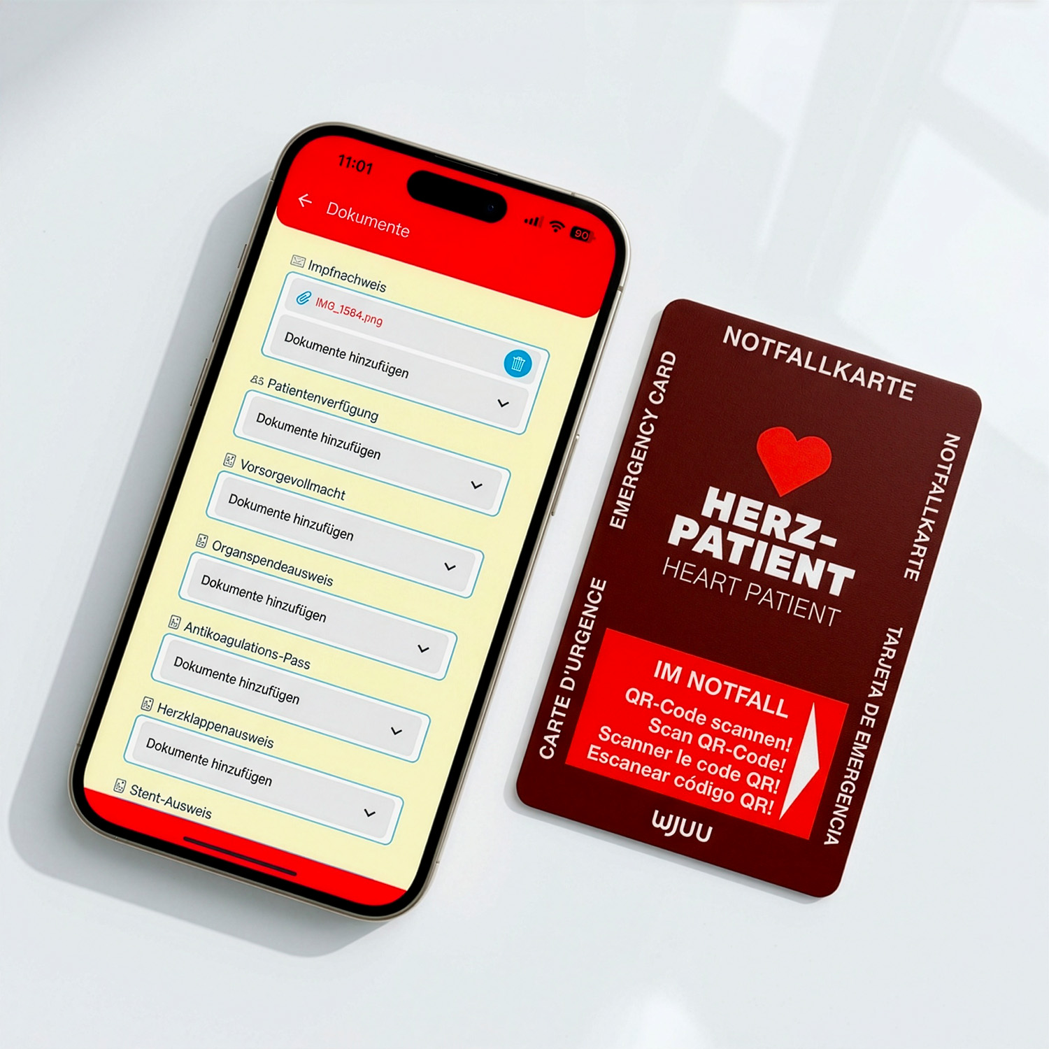 Wjuu Notfallkarte für Herzpatienten neben Smartphone mit digitalem Profil und Dokumenten