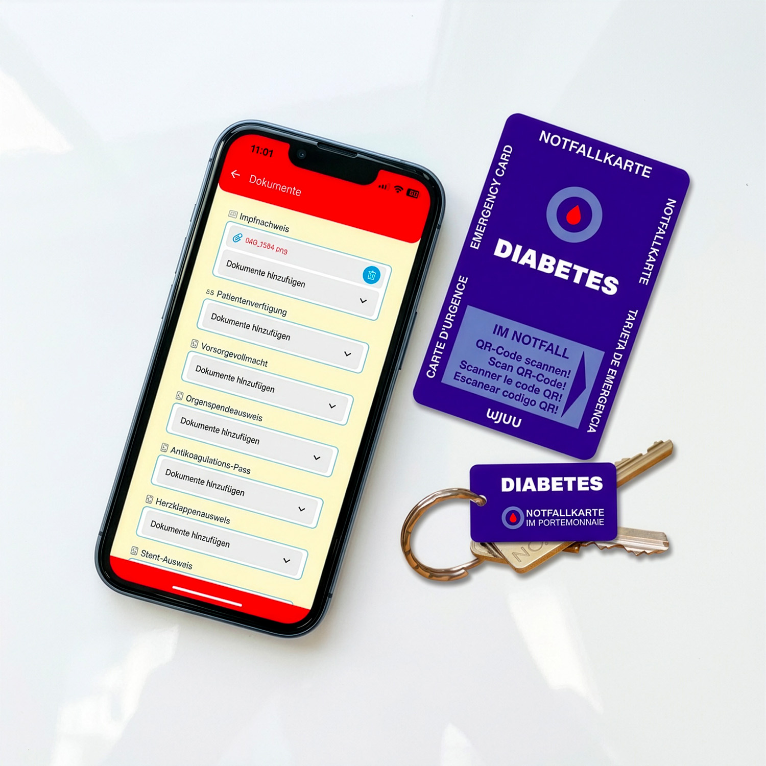 Wjuu Diabetiker Notfallkarte und SOS-Schlüsselanhänger neben Smartphone mit digitalem Profil und Dokumenten