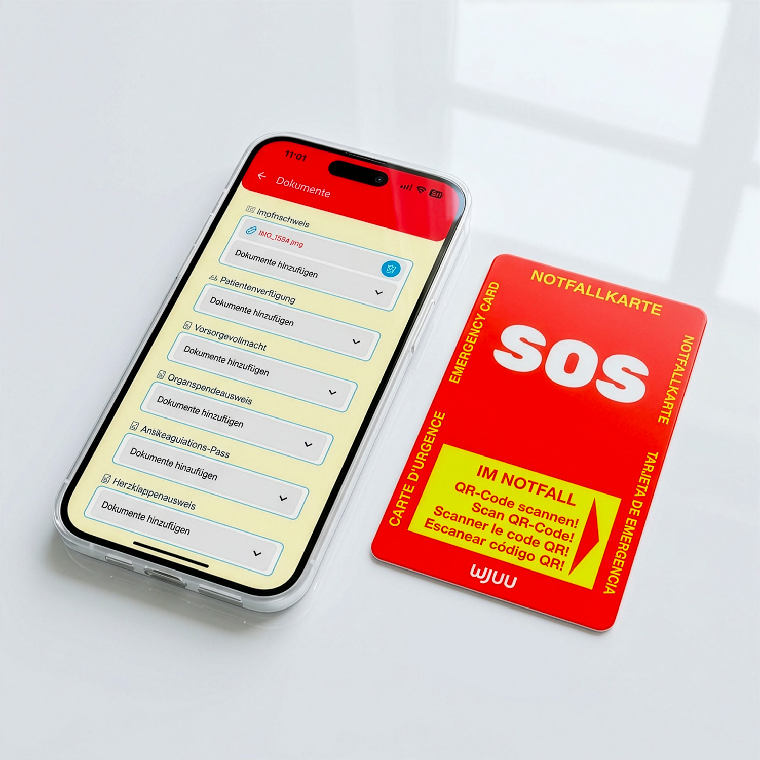 Wjuu Notfallkarte im Scheckkartenformat neben einem Smartphone mit offenem digitalen Notfallprofil und Dokumenten-Uploads